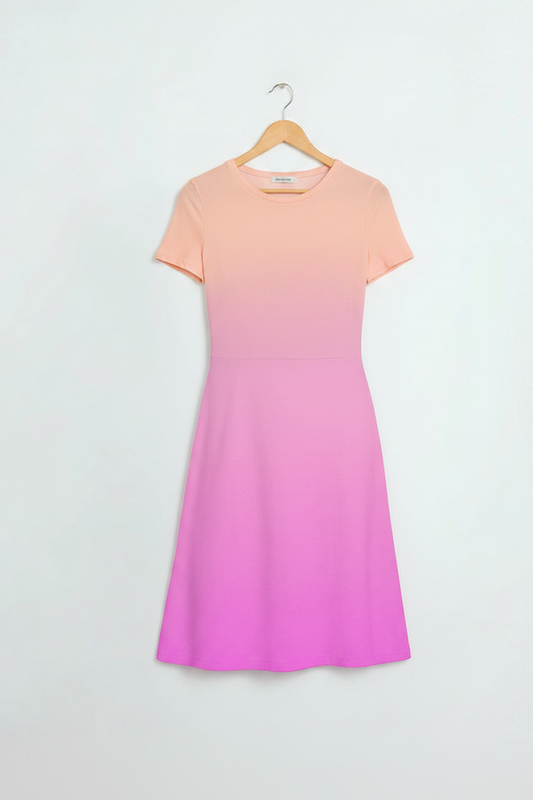 Peach Blossom A-Line Dress hanging on a light birch wood hanger, peach-to-pink gradient, clean minimal white background, product-only shot