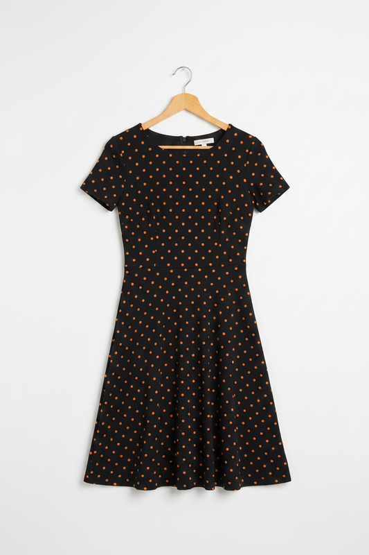 Burnt Orange Charm A-Line Dress - Black A-line dress with orange polka dots on wooden hanger, white studio background